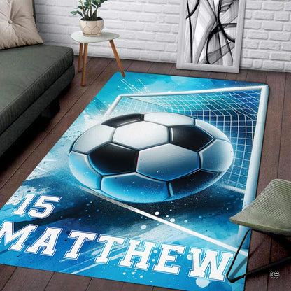 Angled shot of soccer action floor rug exhibiting bright blue hues and abstract sports splatters. - thumbnail image 7 of 8