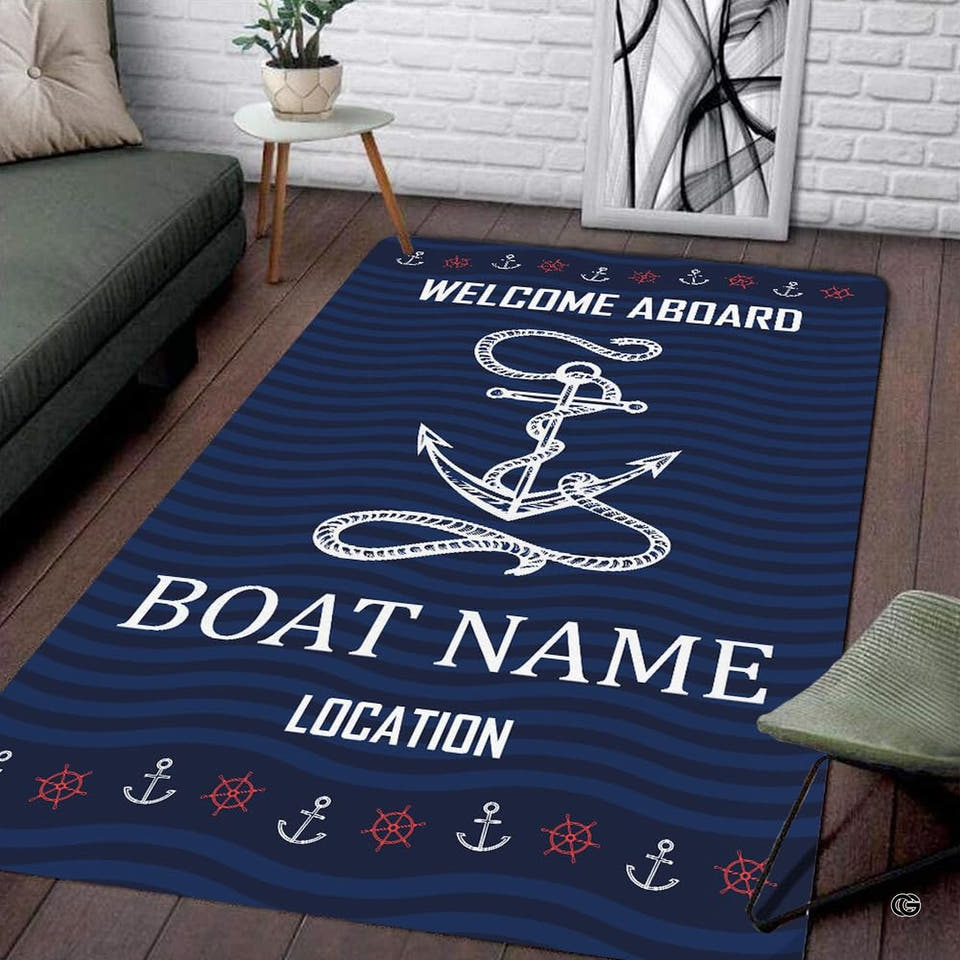 Overhead studio view of rectangular navy blue maritime area rug with large anchor and ship wheels.