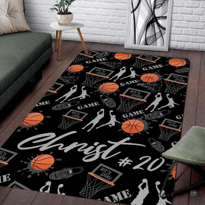 Basketball player on floor motif area rug with orange splatter graphics and athletic silhouettes on black background. - thumbnail image 1 of 7