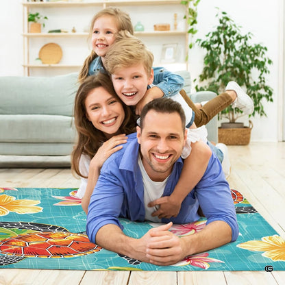 Lifestyle scene featuring family lounging on plumeria sea turtle area rug. - thumbnail image 5 of 7