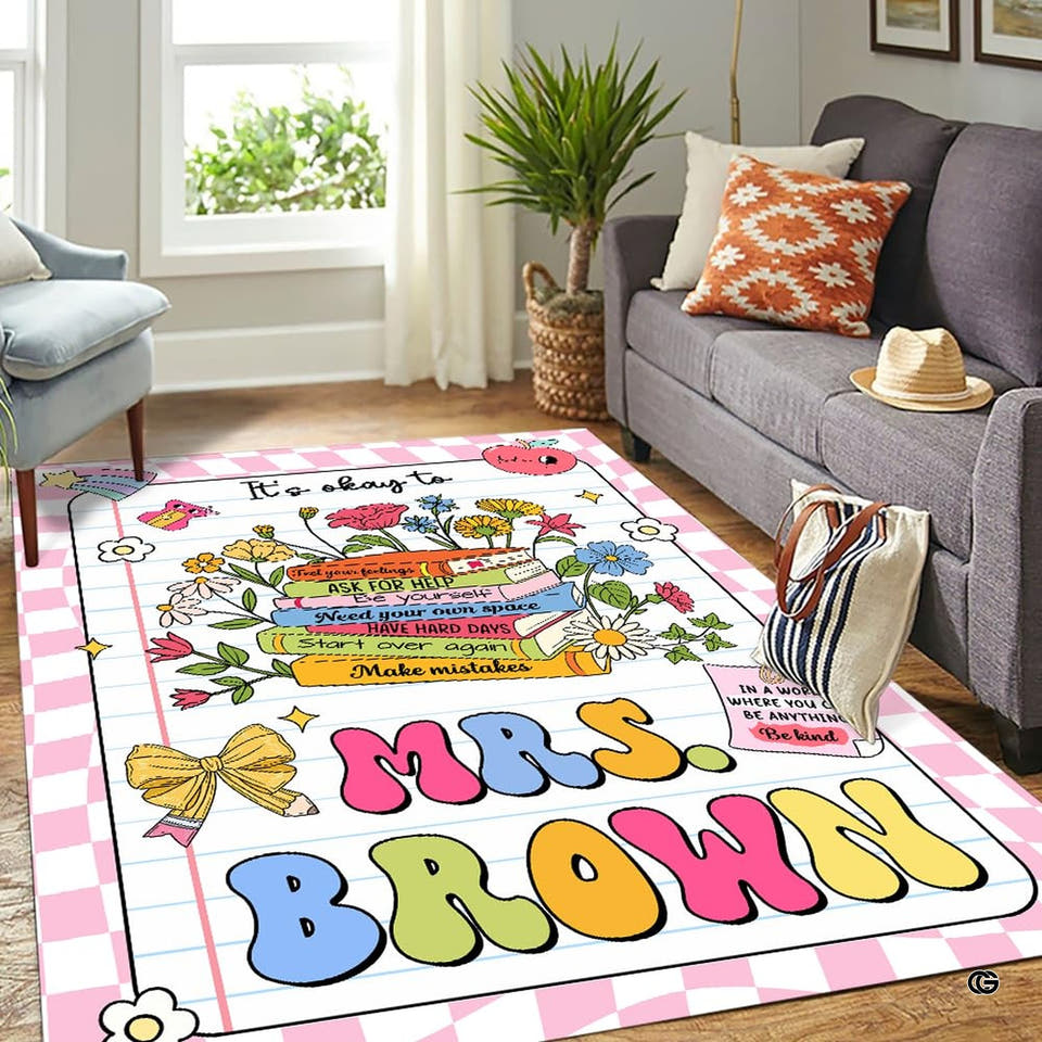 Cozy lounge setting showing the rectangular pink checkered notebook rug with floral doodles on wood flooring.