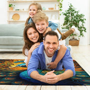 Fireside lounge setting with person relaxing near the fiery golden peacock area rug - thumbnail image 5 of 7