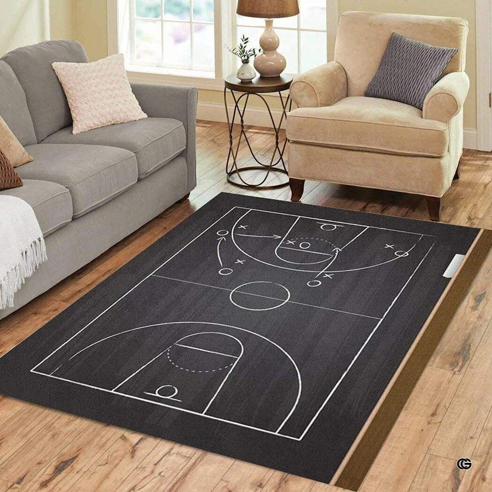 Basketball playbook chalkboard rectangular area rug displayed on wood flooring in a modern living room setting.