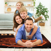 Lifestyle living room scene featuring family lounging on basketball area rug. - thumbnail image 5 of 7