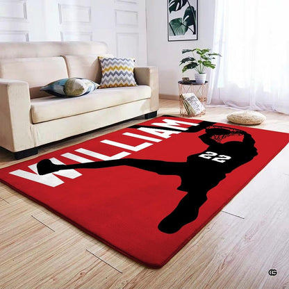 Detailed angle highlighting the hoop silhouette artwork and vivid red tone of this basketball area rug. - thumbnail image 4 of 7