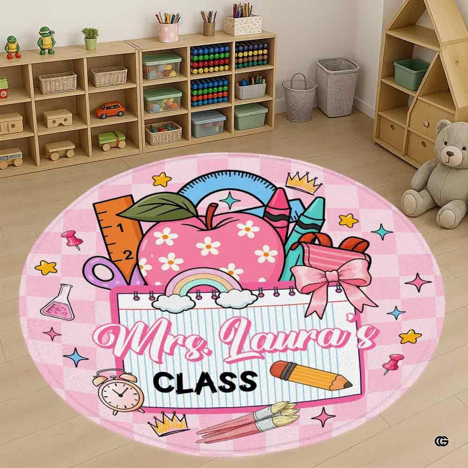 Top-down view of a round area rug with floral apple and stationery illustrations on pink gingham background.