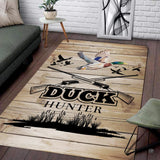 Mallard decorative accent and shotgun illustration on a rustic wood look area rug.