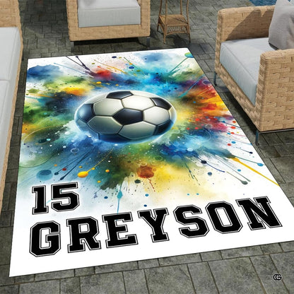 Dynamic soccer ball watercolor splash area rug featuring vibrant cyan and orange paint splatters. - thumbnail image 1 of 8