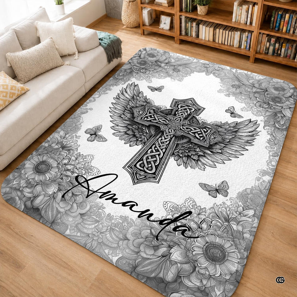 Monochrome Celtic cross area rug with angel wings and florals on light wood flooring