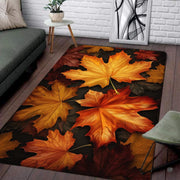 Overhead view of fall maple leaf colors area rug displaying orange and burgundy foliage on a rustic dark brown background. - thumbnail image 1 of 7