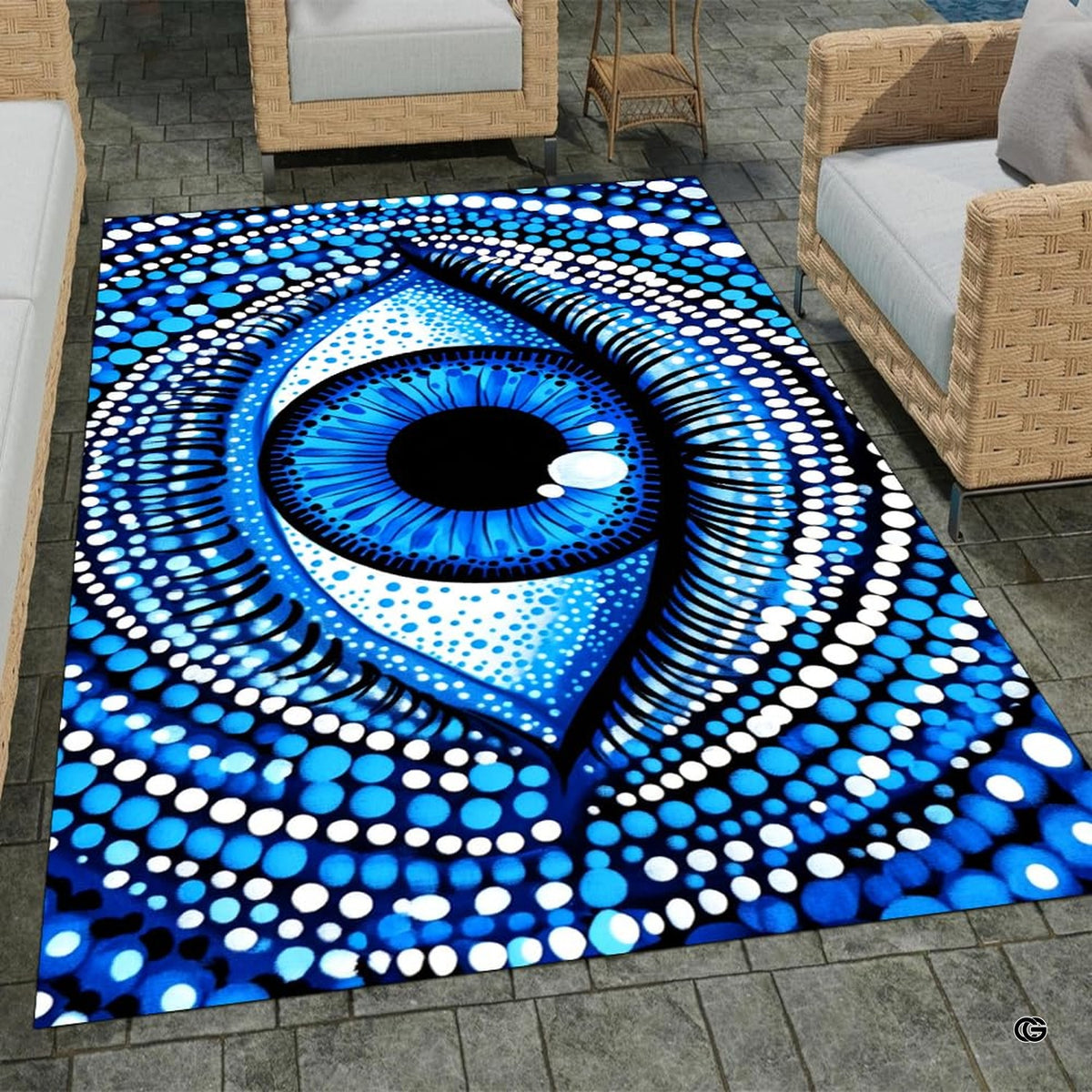 Outdoor patio stone lounge setting displaying the blue dotted evil eye area rug
