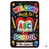 Schoolhouse area rug highlighting a chalkboard illustration of an open storybook and red heart.