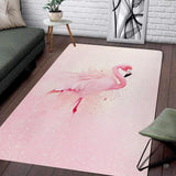 Living room setup with couch and white brick wall showcasing watercolor pink flamingo area rug