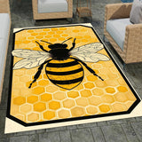Honey bee rug hooking inspired area rug displaying centered bee artwork over golden honeycomb shapes.