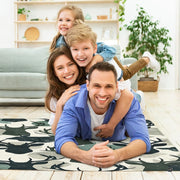 Close-up visual artwork of deer silhouettes layered over watercolor camo patches on a green pattern area rug. - thumbnail image 5 of 7