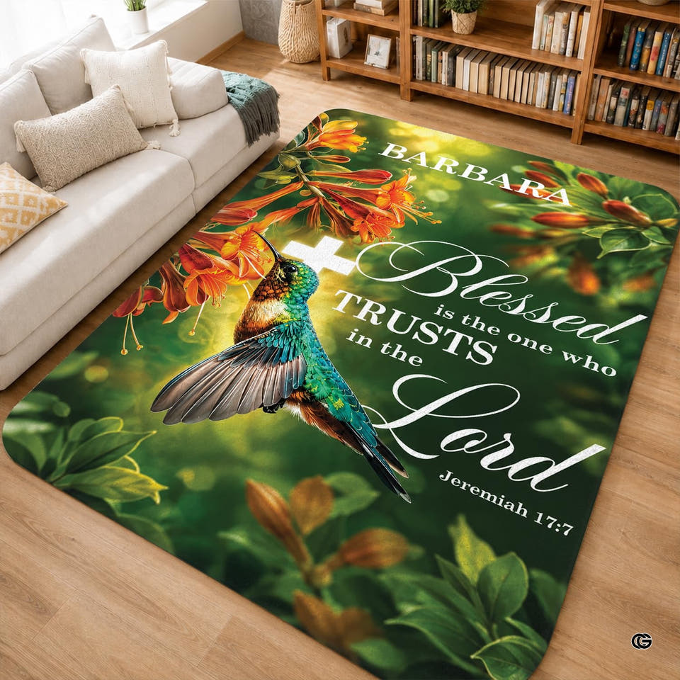 Botanical floral area rug featuring a bird and orange flowers on a light hardwood floor