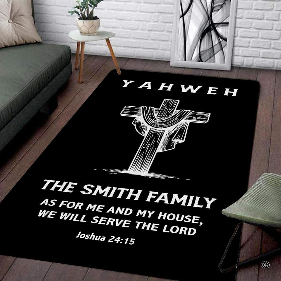 Black and white Christian faith area rug positioned on a wood floor in front of a gray couch
