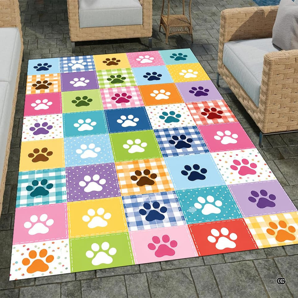 Overhead full perspective of colorful dog paw print patchwork area rug centered on stone patio tiles