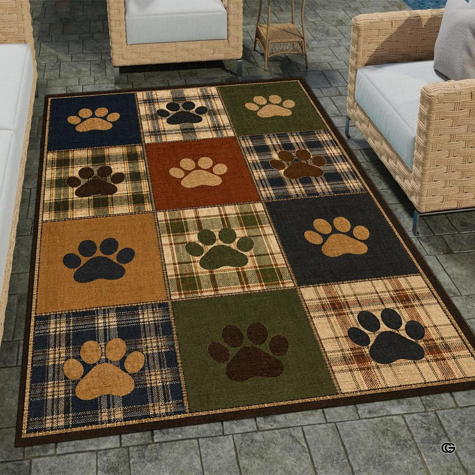 Overhead view of a patchwork plaid animal paw print area rug in rich navy, green, and rust tones.