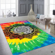 Top down overhead perspective of circular ornate black filigree mandala on a tie dye rug. - thumbnail image 6 of 8