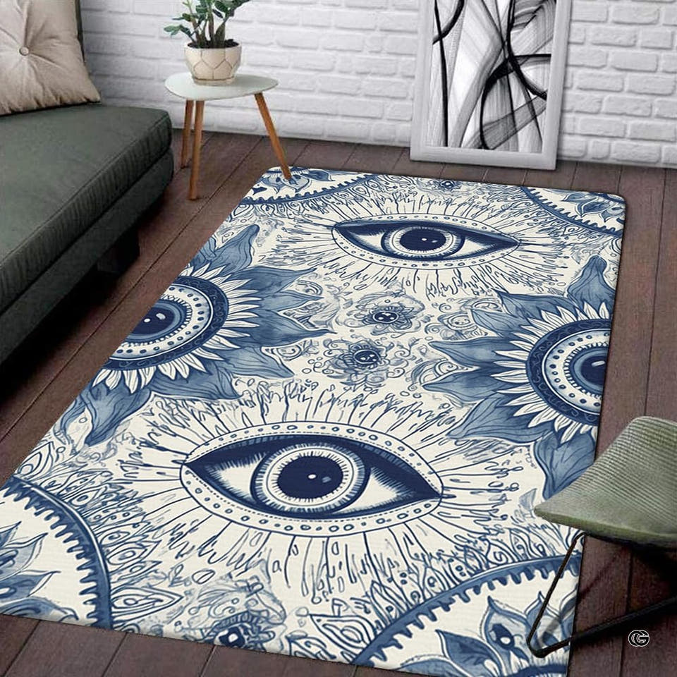 Rectangular floor area rug featuring repeated blue toile celestial sunburst eye pattern on cream ground