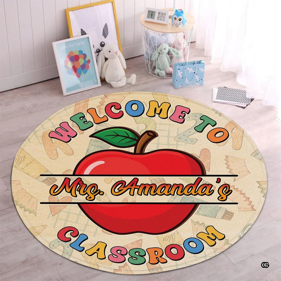Educator red apple circular area rug styled on light wood floorboards in a sunlit preschool playroom.