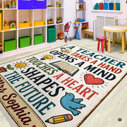 Close-up detail of cream area rug showing the decorative accent-drawn lightbulb, open book, and smiling sun illustrations. - thumbnail image 3 of 7