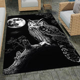 Moonlit horned owl area rug displayed on dark hardwood flooring in a styled modern living room.