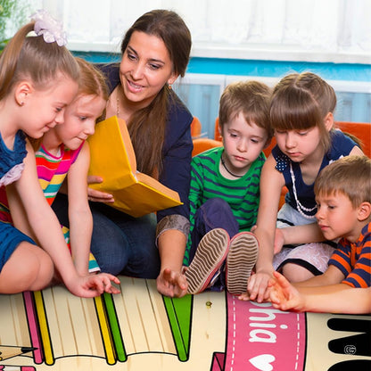 Lifestyle scene featuring teacher and students around book reading rug. - thumbnail image 5 of 7
