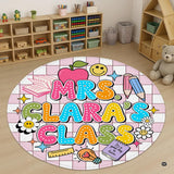 Circular retro floor rug featuring bubble lettering, daisies, and school items on a pink checkerboard grid.