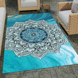 Top view of circular area rug green featuring bold black mandala medallion and fluid turquoise swirls