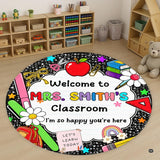 Circular school supply artwork with red apple, books, rainbow, and pencils on a dark chalkboard area rug.