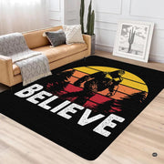 Top-down view of retro Sasquatch area rug showing banded yellow and orange sunset circles on black. - thumbnail image 2 of 5