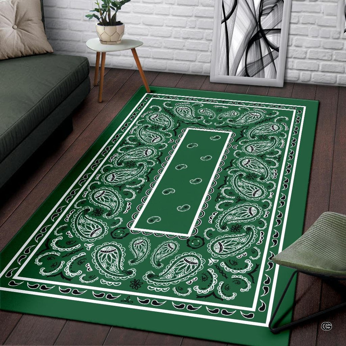 Detailed close-up of teardrop paisley artwork and decorative floral swirls on green bandana area rug.