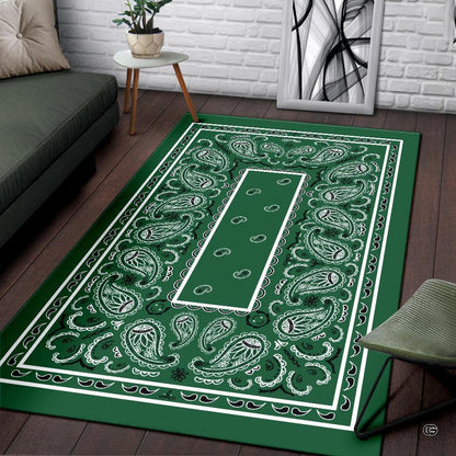 Detailed close-up of teardrop paisley artwork and decorative floral swirls on green bandana area rug. - thumbnail image 3 of 9