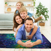 Fireside lounge setting with person relaxing near the midnight blue peacock area rug - thumbnail image 5 of 7