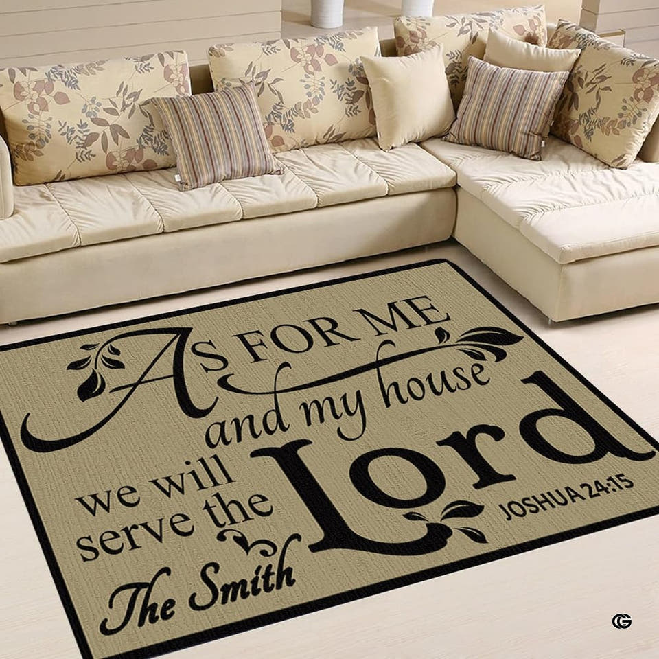 Top-down view of rectangular area rug displaying faith scripture calligraphy on tan background in a living room.