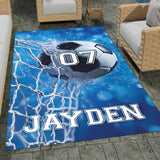 Soccer ball hitting white goal net on blue bokeh background rectangular area rug.