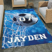 Soccer ball hitting white goal net on blue bokeh background rectangular area rug. - thumbnail image 1 of 8