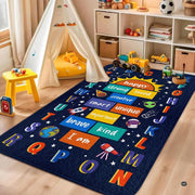 Educational playroom rug with rocket ship, astronaut helmet, and alphabet frame on deep starry navy backdrop. - thumbnail image 2 of 9