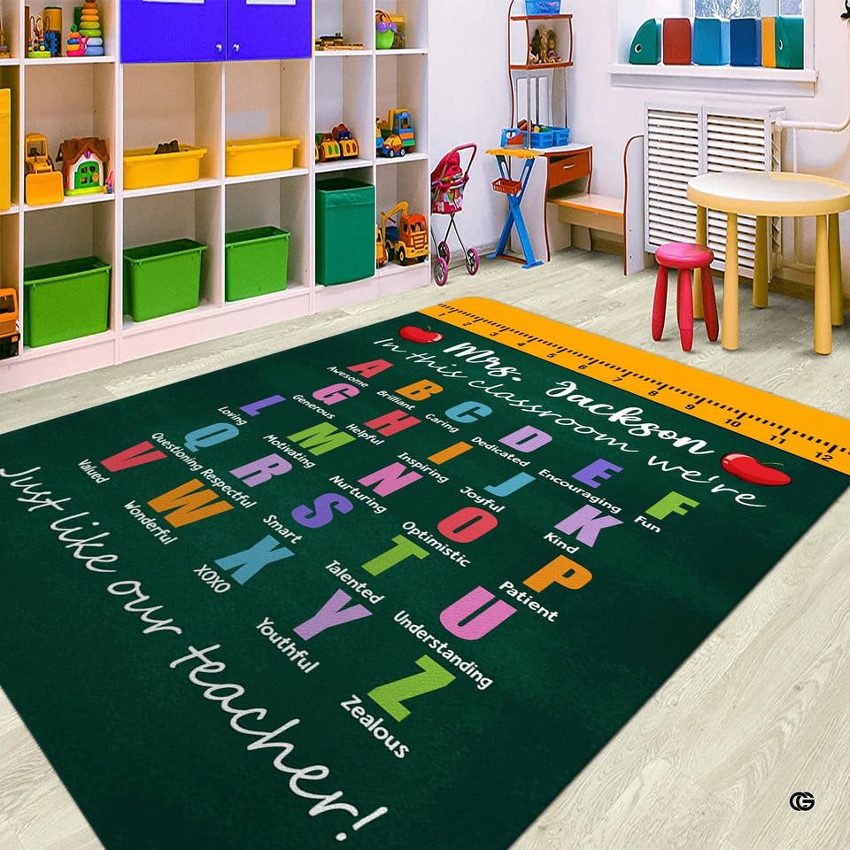 Playroom view presenting a rectangular chalkboard alphabet affirmation area rug on light flooring.