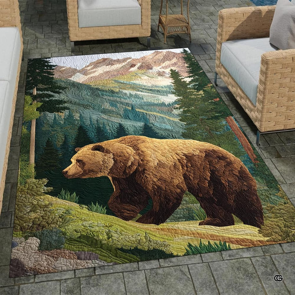 Top-down view of rectangular area rug displaying a grizzly bear walking across a mountain slope.