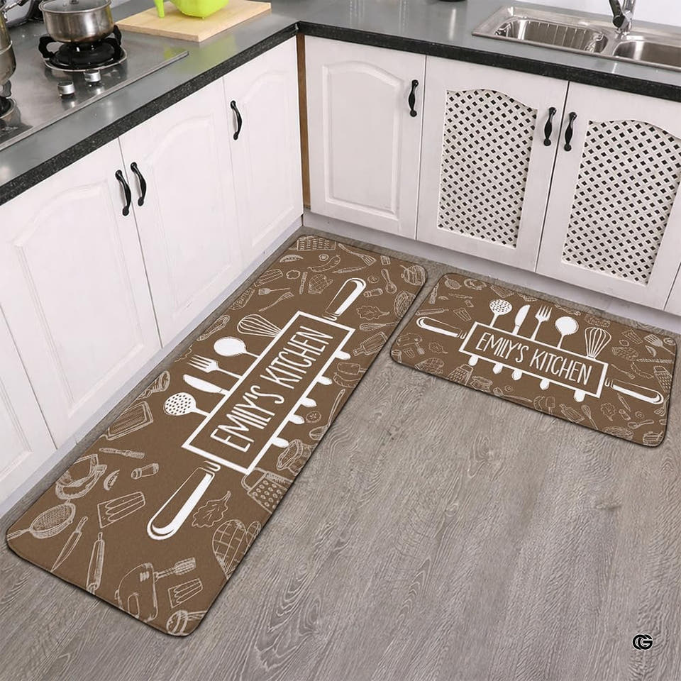 Warm taupe brown area rug featuring white culinary utensil illustrations and rolling pin emblem.