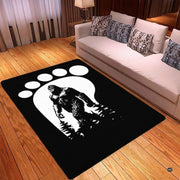 Spacious living room sectional couch setup displaying bigfoot track silhouette monochrome area rug - thumbnail image 3 of 5