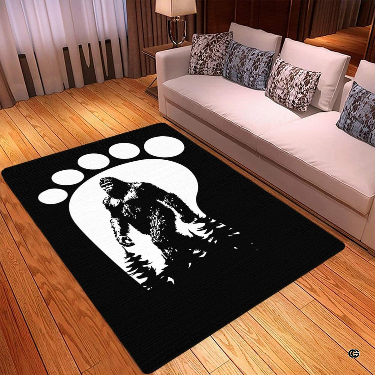 Spacious living room sectional couch setup displaying bigfoot track silhouette monochrome area rug - image 3 of 5