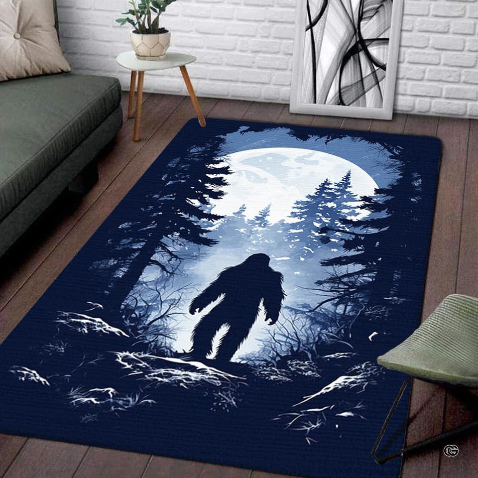Bigfoot silhouette full moon forest rectangular area rug styled beside a couch in a contemporary living room.