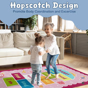 Close-up of vibrant cyan and magenta decorative accent squares on a blush pink decorative area rug. - thumbnail image 4 of 9