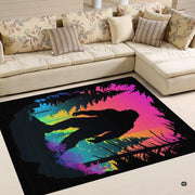 Detailed perspective of Bigfoot silhouette and glowing neon pine trees on an artistic area rug display. - thumbnail image 2 of 5