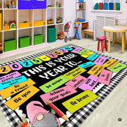 Decorative floor rug placed in a bright children decorative accent area showcasing balanced check and banner artwork. - thumbnail image 6 of 8