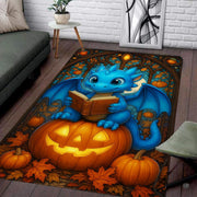 Cute blue baby dragon reading a book seated atop a glowing Halloween pumpkin surrounded by autumn leaves area rug. - thumbnail image 7 of 8